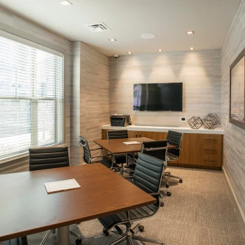 Business meeting space featuring clean design, soft lighting, and minimalistic decor for residents